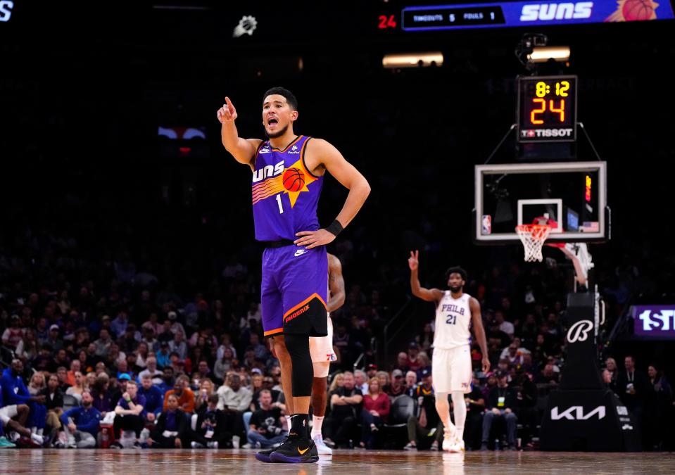 Suns guard Devin Booker (1) yells to his team against the 76ers during a game at Footprint Center in Phoenix on March 25, 2023.