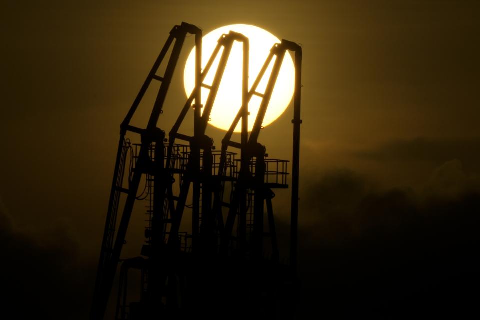 The sun sets near a liquified natural gas power plant at the coastal village of Santa Clara in Batangas province, Philippines on Tuesday, Aug. 8, 2023. The Philippines is seeing one of the world's biggest buildouts of natural gas infrastructure. (AP Photo/Aaron Favila)