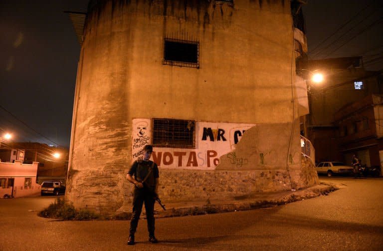 A member of the National Guard takes part in a security operation in the impoverished Petare neighbourhood, one of Caracas' most dangerous slums, on May 13, 2013. Venezuelan police and about 3,000 soldiers are being deployed in areas controlled by opposition leader Henrique Capriles, as part of a plan to fight crime in the country