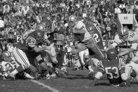 FILE - Dallas Cowboys running back Dan Reeves (30) is airborne as he comes through the line for short gain during the second period of an NFL football game against the Philadelphia Eagles on Oct. 29, 1967, in Philadelphia. Reeves, who won a Super Bowl as a player with the Cowboys but was best known for a long coaching career that included four blowout losses in the title game with the Denver Broncos and the Atlanta Falcons, died Saturday, Jan. 1, 2022. He was 77. (AP Photo/Bill Ingraham, File)