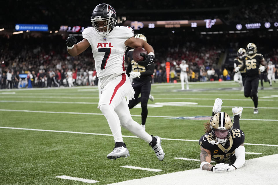 Atlanta Falcons running back Bijan Robinson (7) runs in for a touchdown against New Orleans Saints safety Tyrann Mathieu (32) in the first half of an NFL football game against the New Orleans Saints in New Orleans, Sunday, Jan. 7, 2024. (AP Photo/Gerald Herbert)