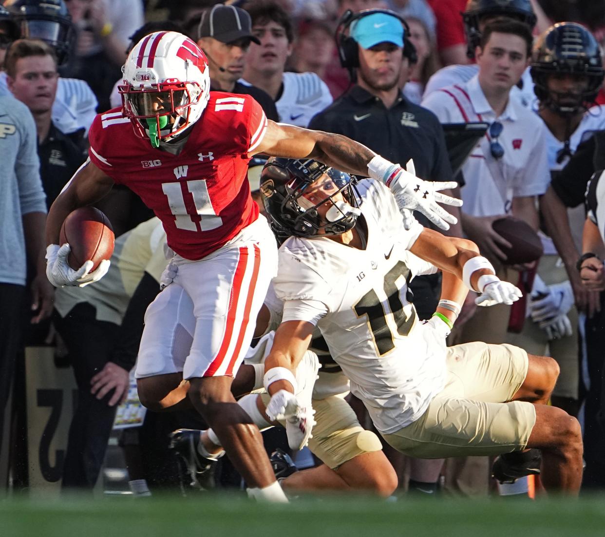 Wisconsin wide receiver Skyler Bell (11) sheds a tackle by Purdue safety Cam Allen (10) to pick up 18 yards during the  third quarter of their game at Camp Randall Stadium Saturday, October 22, 2022 in Madison, Wis. Wisconsin beat Purdue 35-24.