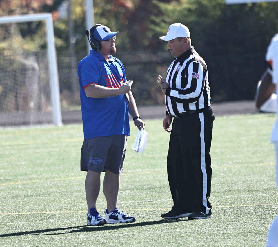 Then-Woodward head football coach Jeremy Pflug talks with an official during a football game against Withrow Saturday, Oct. 8.