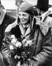 American aviatrix Amelia Earhart poses with flowers as she arrives in Southampton, England, after her transatlantic flight on the "Friendship" from Burry Point, Wales, on June 26, 1928. The tri-motor "Friendship" was piloted by two men as Earhart served as the commander, making her the first woman passenger to fly across the Atlantic. (AP Photo)