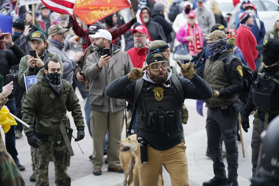 FILE - In this Jan. 6, 2021, file photo, Trump supporters gather outside the Capitol in Washington. As rioters converged on the U.S. Capitol building, the grounds normally hailed as the seat of American democracy became a melting pot of extremist groups. Militia members, white supremacists, paramilitary organizations and fervent supporters of outgoing President Donald Trump stood shoulder to shoulder, unified in rage. Experts say years of increasing partisanship and a growing fascination of paramilitary groups combined with the coronavirus pandemic to create a conveyor belt of radicalization. (AP Photo/Manuel Balce Ceneta, File)