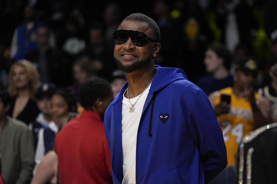 CORRECTS PERSON TO TEE MORANT, INSTEAD OF USHER - Tee Morant, father of Memphis Grizzlies' Ja Morant, stands on the sideline before an NBA basketball game between the Grizzlies and the Los Angeles Lakers in Los Angeles, Friday, Jan. 20, 2023. (AP Photo/Ashley Landis)