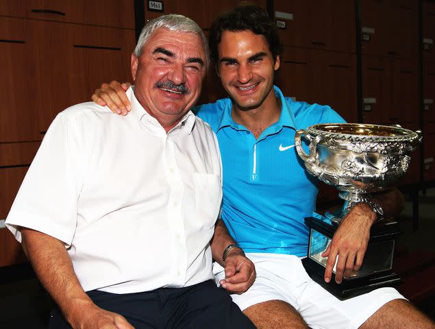 <p>Clive Brunskill/Getty</p> Roger Federer and his father Robert Federer pose with the Norman Brookes Challenge Cup on January 31, 2010 in Melbourne, Australia.