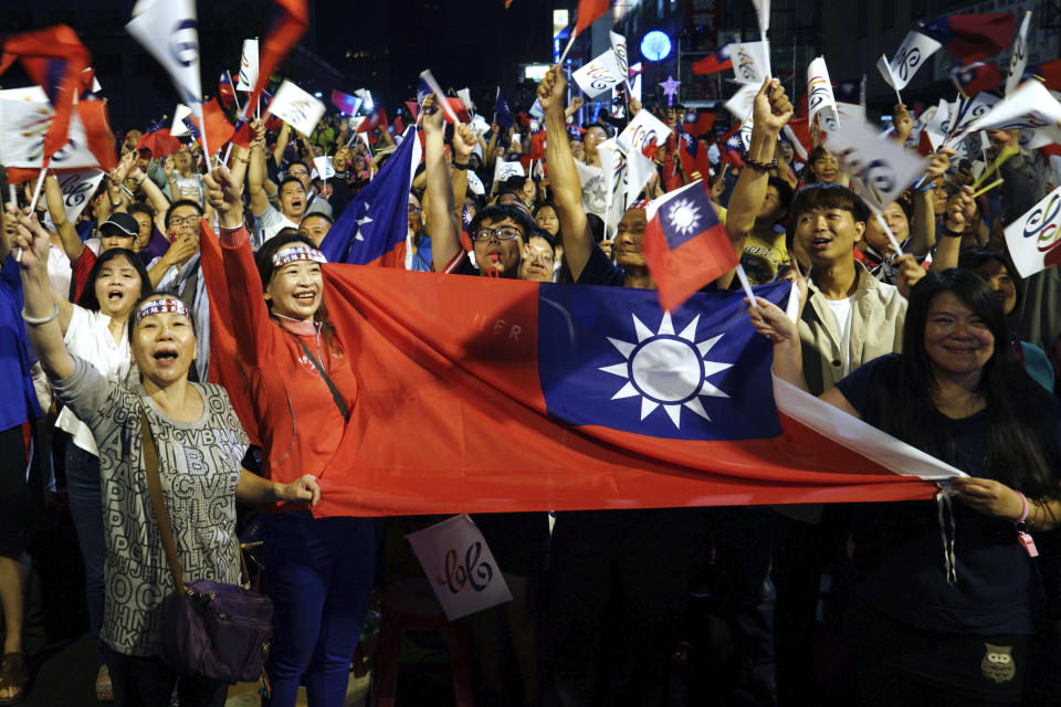 FILE - In this Nov. 24, 2018, file photo, supporters of the opposition Nationalist Party cheer in Kaohsiung, Taiwan. China says it will not "renounce the use of force" in efforts to reunify Taiwan with the mainland and vows to take all necessary military measures to defeat "separatists."(AP Photo/File)