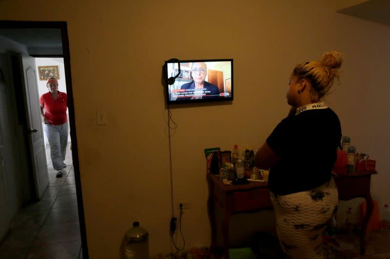 A cuban migrant watches television at her home after media announced that Democratic U.S. presidential nominee Joe Biden has won the 2020 U.S. presidential election in Ciudad Juarez