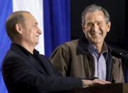 U.S. President George W. Bush shares a laugh with Russian President Vladimir Putin as the two answer questions at the Crawford High School in Crawford, Texas, in this November 15, 2001 file photo. To match Special Report UKRAINE-PUTIN/DIPLOMACY REUTERS/Win McNamee/Files (UNITED STATES - Tags: POLITICS)