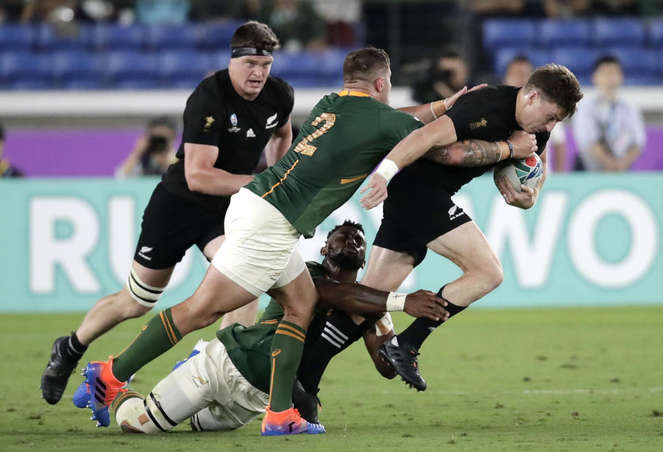 New Zealand's Beauden Barrett, right, attempts to break the tackle of South Africa's Malcolm Marx during the Rugby World Cup Pool B game at International Stadium between New Zealand and South Africa in Yokohama, Japan, Saturday, Sept. 21, 2019. (AP Photo/Jae Hong)