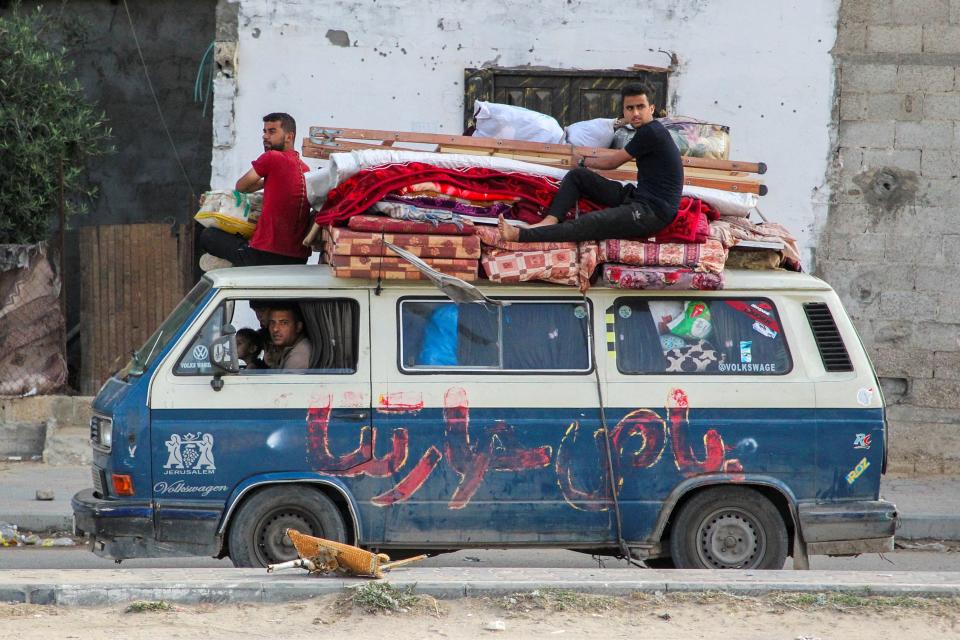 Displaced Palestinians travel in a vehicle as they flee Rafah (REUTERS)