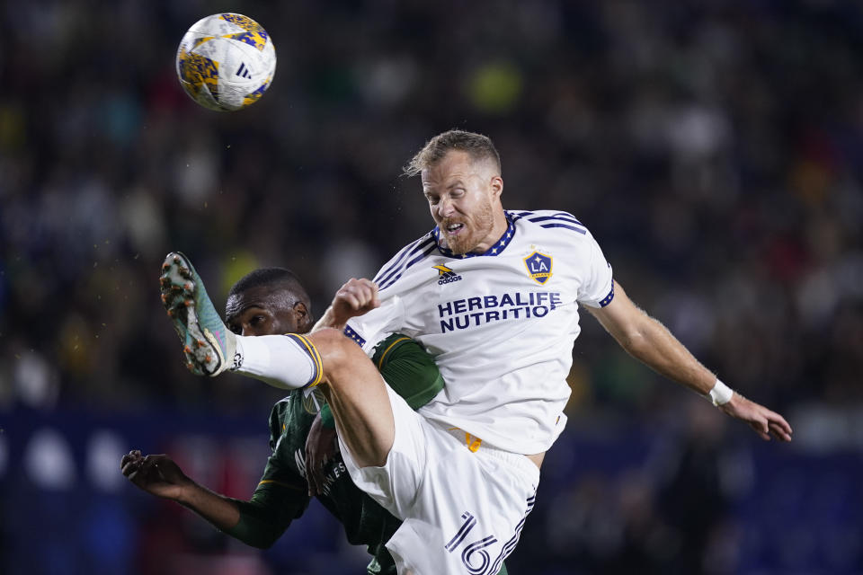 LA Galaxy midfielder Oriol "Uri" Rosell, right, extends for the ball past Portland Timbers defender Juan David Mosquera during the second half of an MLS soccer match, Saturday, Sept. 30, 2023, in Carson, Calif. (AP Photo/Ryan Sun)