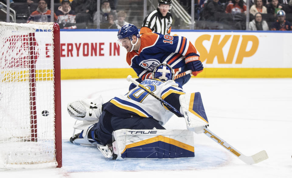 Edmonton Oilers' Zach Hyman (18) scores against St. Louis Blues goalie Jordan Binnington (50) during the second period of an NHL game in Edmonton, Alberta, on Wednesday Feb. 28, 2024 (Jason Franson/The Canadian Press via AP)