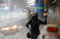 A protestor prepares to throw molotov cocktail in Hong Kong, Sunday, Sept. 29, 2019. Riot police fired tear gas Sunday after a large crowd of protesters at a Hong Kong shopping district ignored warnings to disperse in a second straight day of clashes, sparking fears of more violence ahead of China's National Day. (AP Photo/Vincent Thian)