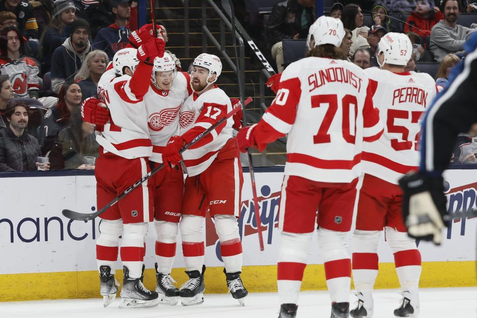 Detroit Red Wings players celebrate their goal against the Columbus Blue Jackets during the first period of an NHL hockey game on Sunday, Dec. 4, 2022, in Columbus, Ohio.