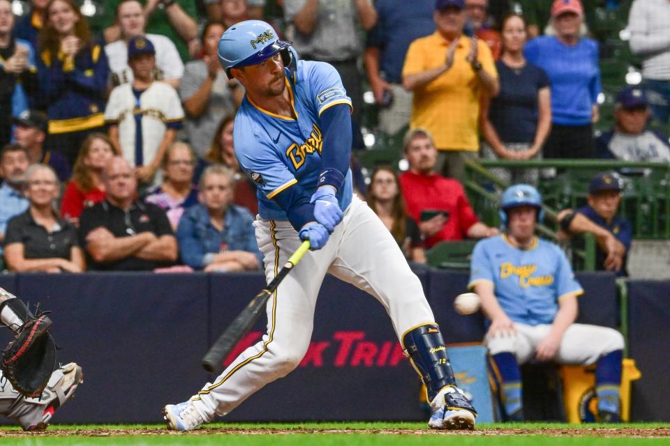 Milwaukee Brewers first baseman Rhys Hoskins (12) drives in the tying run with a base hit in the eighth inning against the Arizona Diamondbacks at American Family Field.