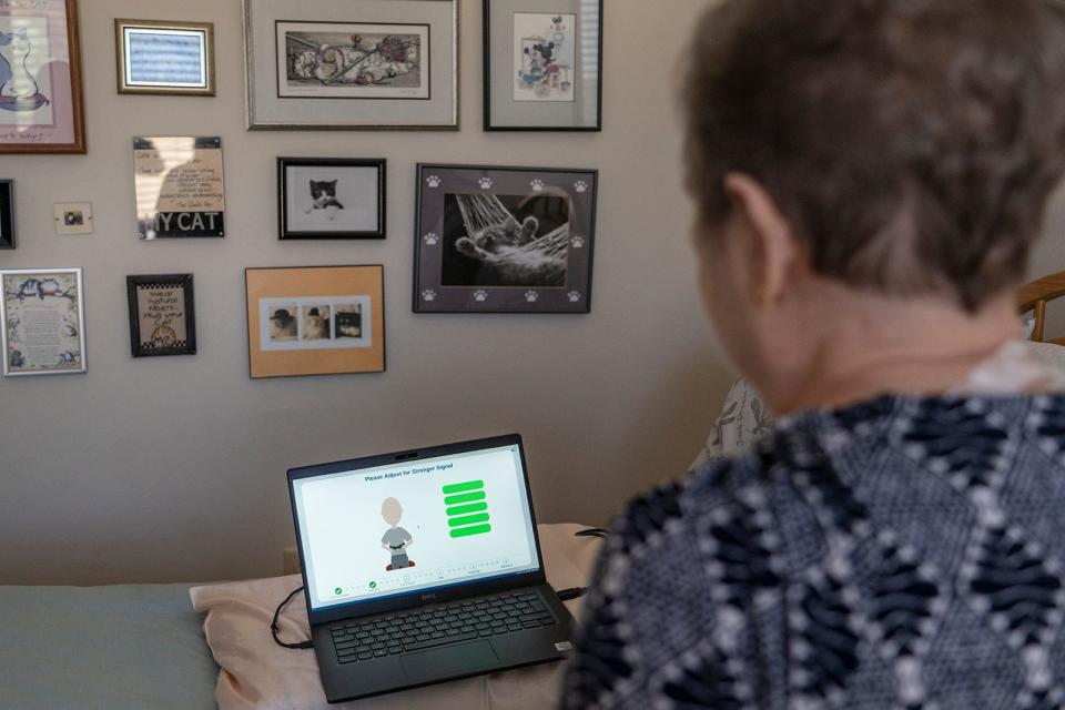 Donna Whitworth opens the laptop to gets ready to connect to the Fire1 device. Because she is in a study, she cannot see the data that the device is charting.