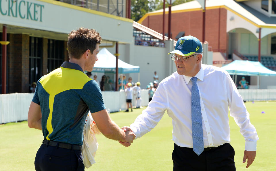 Prime Minister Scott Morrison (pictured right) shaking hands with Australian captain Tim Paine (pictured left).