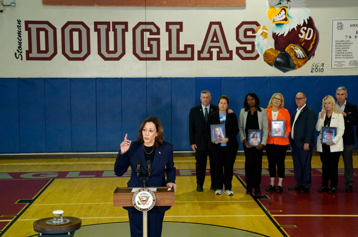 Families hold portraits of the victims of the 2018 shooting at Marjory Stoneman Douglas High School as Vice President Kamala Harris speaks about gun safety measures (AFP via Getty Images)