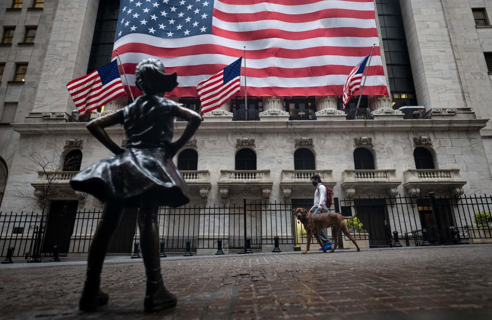 The Fearless Girl statue  is seen in front of the New York Stock Exchange (NYSE) on April 30, 2020 in New York City. - Wall Street stocks opened lower Thursday following another spike of jobless claims in the wake of coronavirus shutdowns, offsetting strong results from tech giants. Another 3.84 million US workers filed for unemployment benefits last week and the total has now passed 30 million in six weeks, according to the Labor Department data. (Photo by Johannes EISELE / AFP) (Photo by JOHANNES EISELE/AFP via Getty Images)