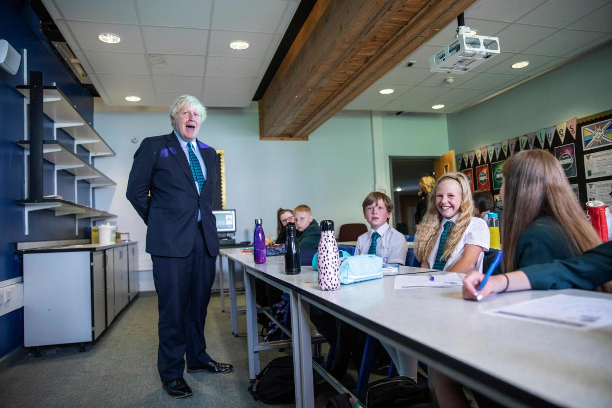 Britain's Prime Minister Boris Johnson talks to a class of year seven pupils on their first day at Castle Rock school, Coalville, central England on August 26, 2020. (Photo by Jack Hill / POOL / AFP) (Photo by JACK HILL/POOL/AFP via Getty Images)