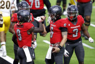 UNLV quarterback Max Gilliam, center, celebrates with teammates after scoring a touchdown against Wyoming during the first half of an NCAA college football game in Las Vegas on Friday, Nov. 27, 2020. (Steve Marcus/Las Vegas Sun via AP)