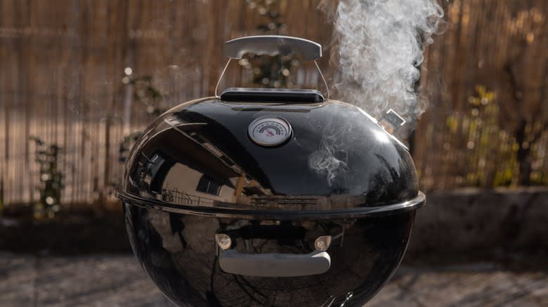 charcoal grill with smoke