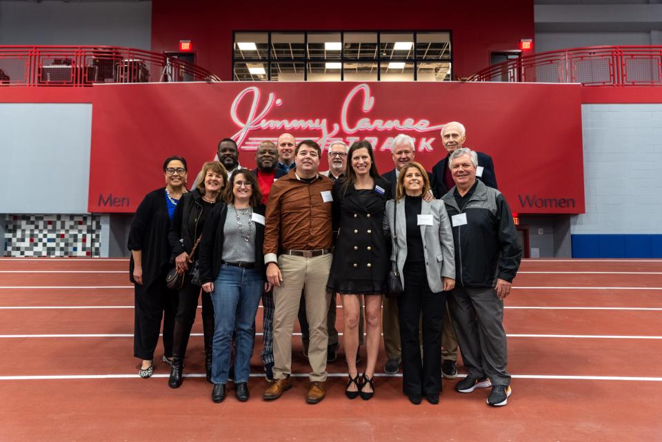 The track at the new Alachua County Sports and Events Center in Celebration Pointe was dedicated on Saturday in honor of the late Jimmy Carnes. Pictured at the dedication are, first row, from left, Rochelle Tryar, Dr. Heather Gibson, Lynda Reinhart, Adam Anderson, Joleen Cacciatore Miller, Dr. Kyriaki Kaplanidou and Rick McGinnis. Back row, from left: Elliot Harris, Mike Powell, Weston Gallop, Ron Gromoll, Richard Blalock and Frank Saier