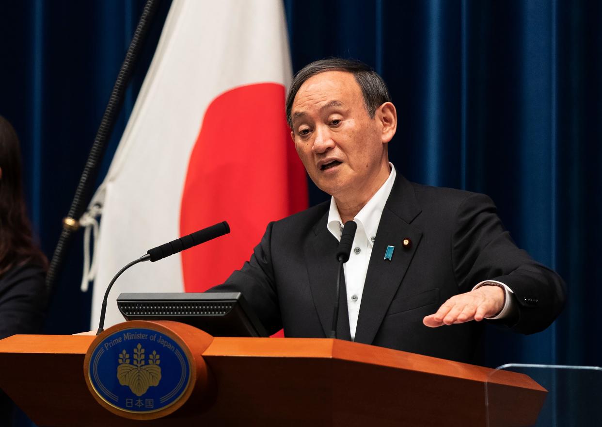 Japanese Prime Minister Yoshihide Suga responds to a reporter's question at a news conference in Tokyo on Friday.