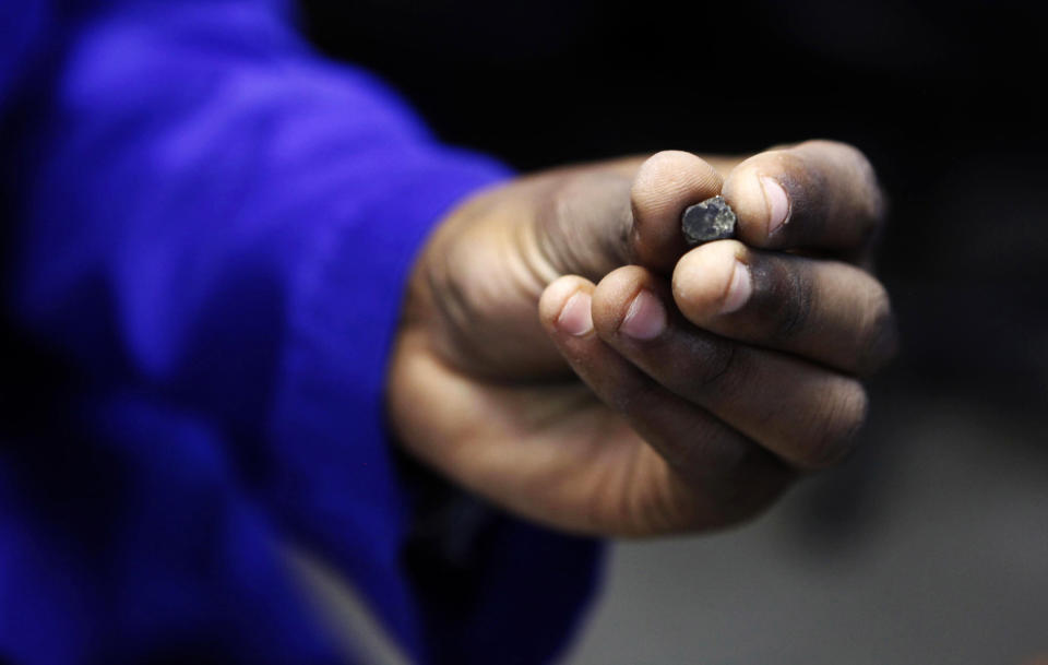 A Zimbabwean worker holds a piece of rough diamond from the country's Marange diamond fields. Rough diamonds from the diamond fields were detained by federal agents on Monday under suspicions that they were mined from forced labor. (Photo: Philimon Bulawayo/Reuters)