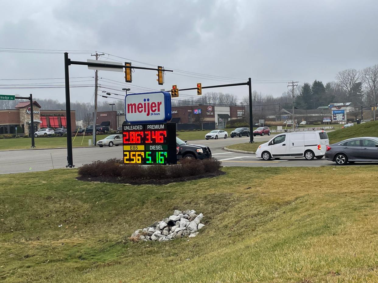 Experts say gas prices, like this at the Meijer in Brimfield Township, are expected to continue to fall through Christmas.