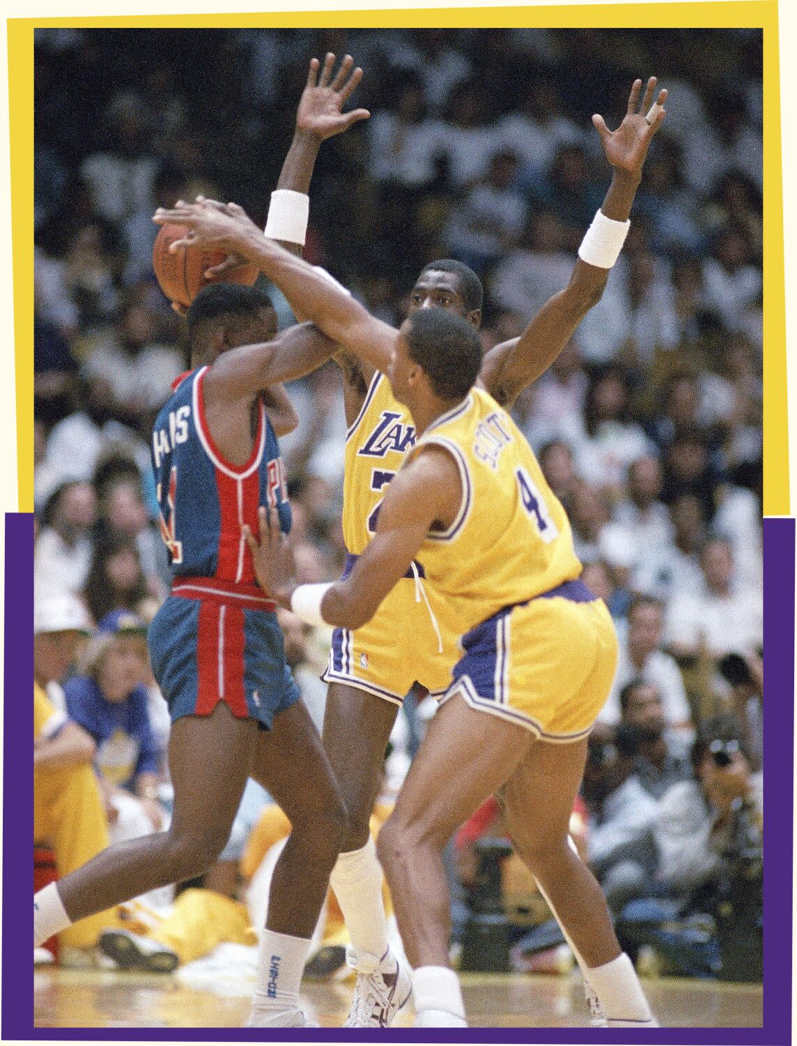 A photo of three basketball players, one with the ball in his hands and two opponents guarding him