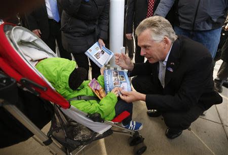 Virginia Democrat gubernatorial candidate Terry McAuliffe greets toddler Ozzie Springer of Centreville, VA, outside a metro station in Fairfax, Virginia, on election day November 5, 2013. REUTERS/Kevin Lamarque