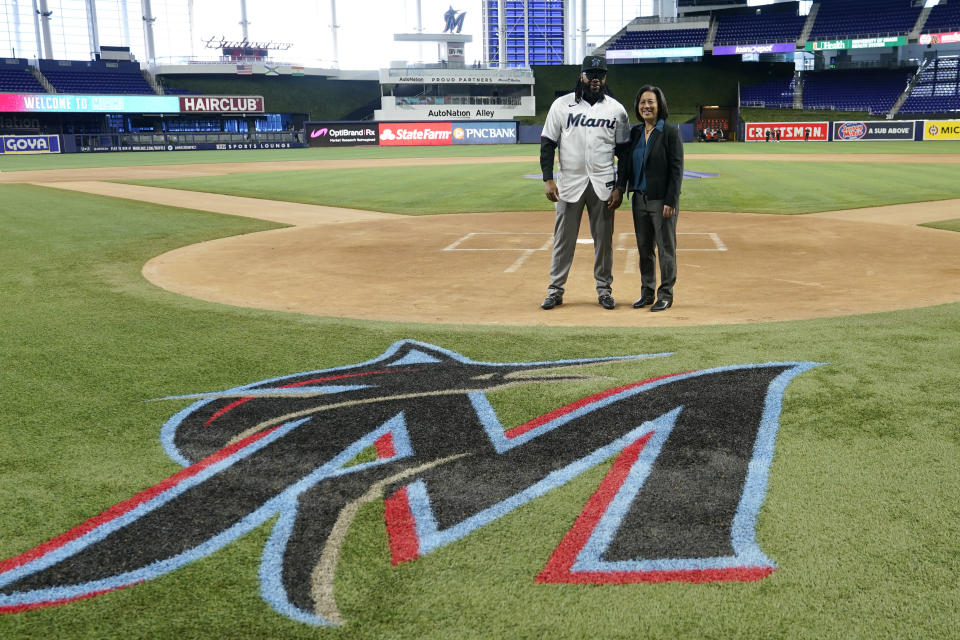 Pitcher Johnny Cueto, left, poses for a photograph with Miami Marlins General Manager Kim Ng, after signing a contract with the Miami Marlins baseball team, Thursday, Jan. 19, 2023, in Miami. Cueto signed a one-year contract with the Marlins with a club option for 2024. (AP Photo/Lynne Sladky)