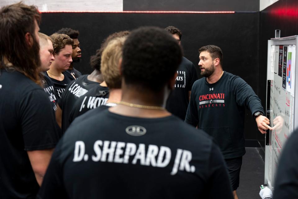 Cincinnati Bearcats Football Sports Performance director Niko Palazeti leads the Cincinnati Bearcats defensive line through a weight lifting session on at The Lindner Center in Cincinnati on Thursday, Feb. 9,