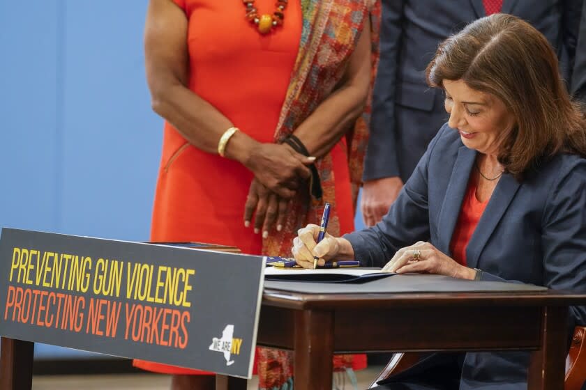 New York Gov. Kathy Hochul signs a package of bills to strengthen gun laws, Monday, June 6, 2022, in New York. New York has strengthened gun laws as part of a series of laws signed this week by Gov. Kathy Hochul with the hope to lessen gun violence and gun-related deaths. Hochul, a Democrat, signed 10 gun-related bills Monday. (AP Photo/Mary Altaffer)