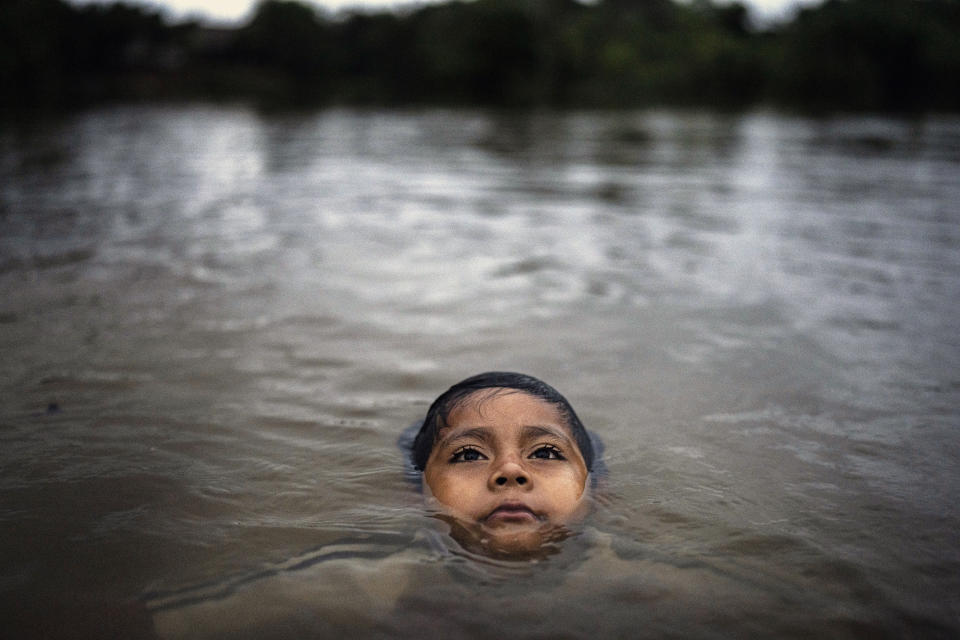 Maijuna youth Segundo Jeinsen bathes in a stream in Sucusari, Peru, Wednesday, May 29, 2024. A federal highway project in an untouched area of the Peruvian Amazon is facing mounting opposition from Indigenous tribes, including the Maijuna. (AP Photo/Rodrigo Abd)