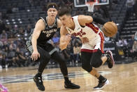 Miami Heat guard Tyler Herro (14) drives past Sacramento Kings guard Kevin Huerter (9) during the first quarter of an NBA basketball game in Sacramento, Calif., Saturday, Oct. 29, 2022. (AP Photo/Randall Benton)