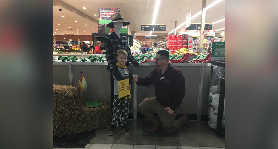 Jaxon being thanked for his donation, which he took in to Woolworths on Saturday. Source: Supplied