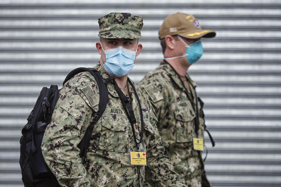 US Navy personnel wearing surgical masks to protect against the coronavirus, arrive at Wyckoff Heights Medical Center, Tuesday, April 7, 2020, in the Brooklyn borough of New York. The new coronavirus causes mild or moderate symptoms for most people, but for some, especially older adults and people with existing health problems, it can cause more severe illness or death. (AP Photo/John Minchillo)