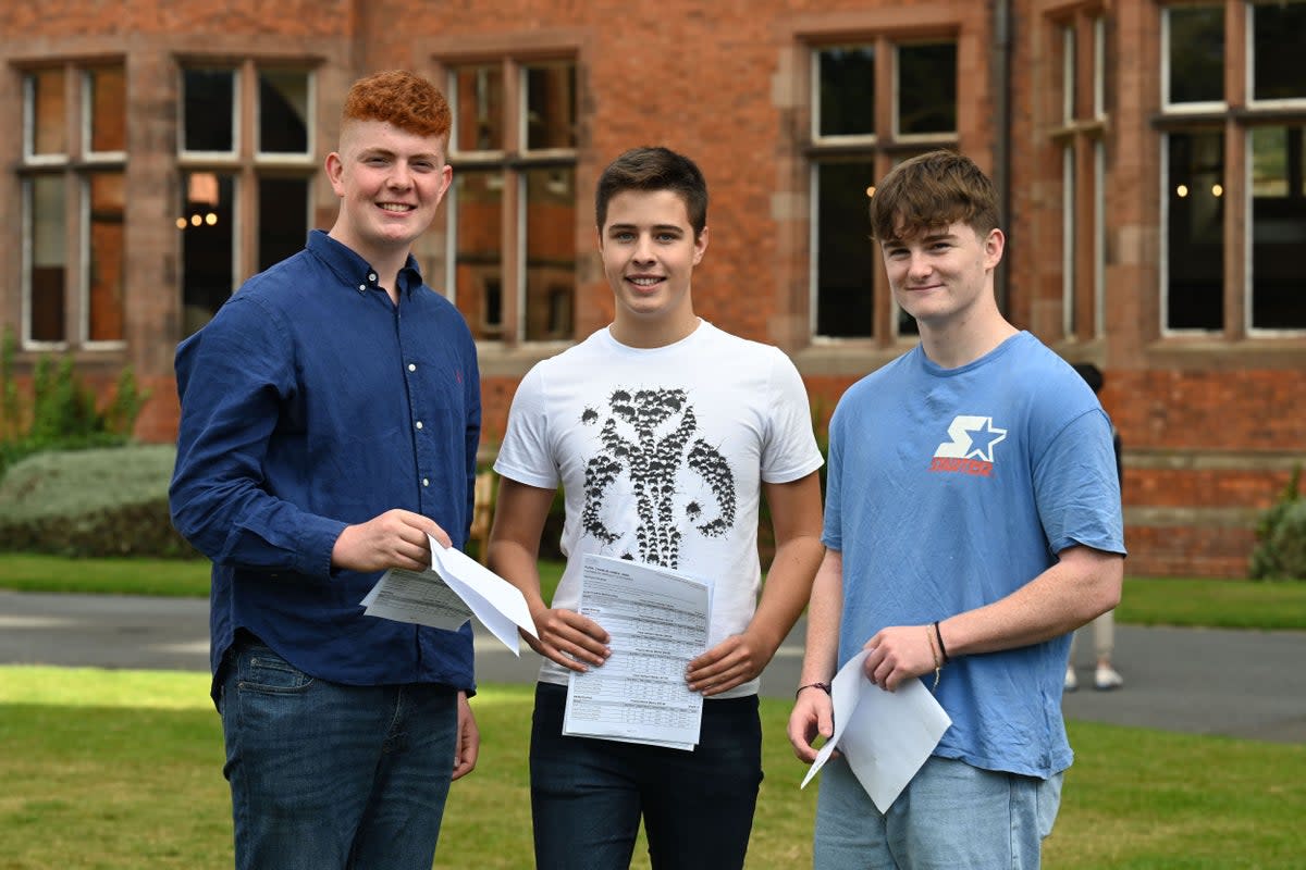 Alex Meyer (left), Charlie Pugh and James McConnell (right) who all achieved a straight set of A star/A’s in their GCSE’s at Campbell College, Belfast, Northern Ireland (Michael Cooper/PA) (PA Media)