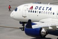 A Delta Air Lines jet leaves the gate during a global technology outage at Logan International Airport, Friday, July 19, 2024, in Boston. (AP Photo/Michael Dwyer)