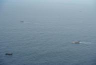 Fishing boats are seen from an aircraft of the Ecuadorian navy after a fishing fleet of mostly Chinese-flagged ships was detected in an international corridor that borders the Galapagos Islands' exclusive economic zone, in the Pacific Ocean