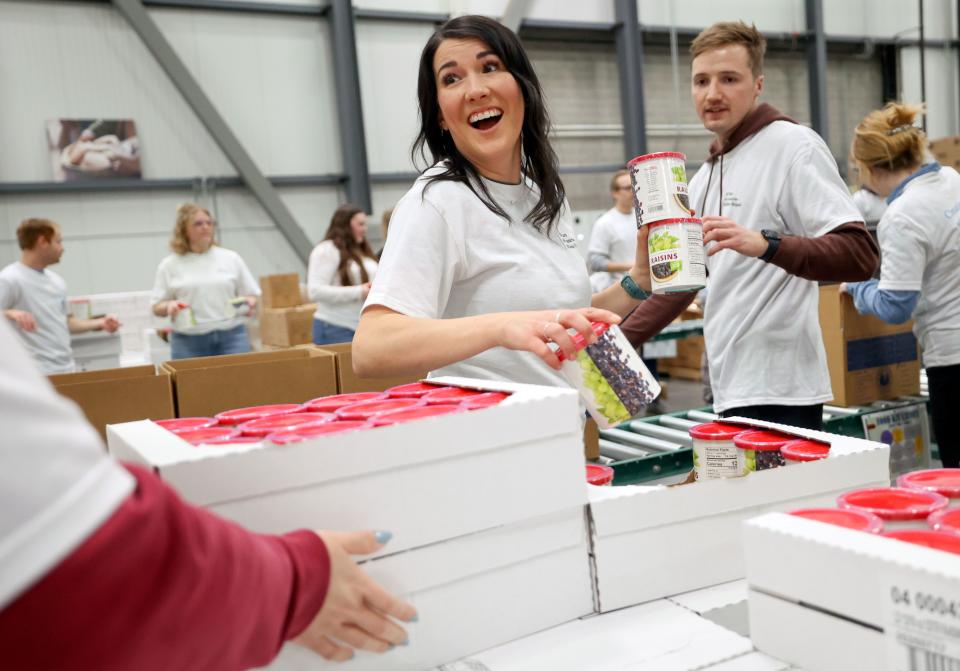 Kambri Jackman boxes food during a service day, hosted by The Church of Jesus Christ of Latter-day Saints, to commemorate the 10th anniversary of its relationship with the United Nations World Food Programme and World Food Program USA, at Bishops’ Central Storehouse in Salt Lake City on Thursday, Feb. 8, 2024. | Kristin Murphy, Deseret News