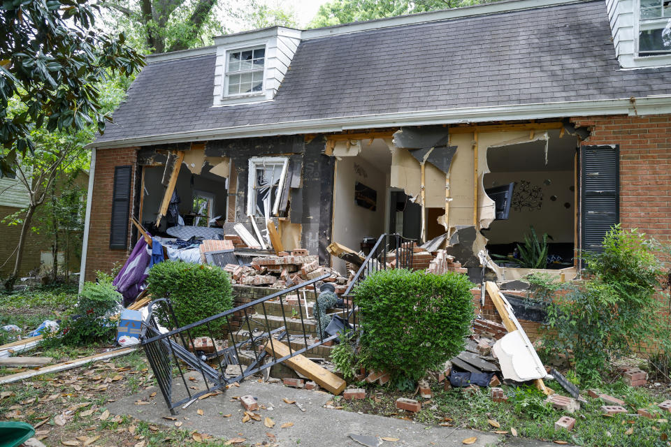 Debris covers a home on Tuesday, April 30, 2024, where a shootout between a suspect and officers occurred on Monday, in Charlotte, N.C. Police say a shootout that killed four law enforcement officers and wounded four others began as officers approached the home to serve a warrant for a felon wanted for possessing a firearm. (AP Photo/Nell Redmond)