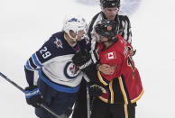 Winnipeg Jets' Patrik Laine (29) and Calgary Flames' Matthew Tkachuk (19) get in each other's face during the second period of an NHL hockey playoff game Saturday, Aug. 1, 2020 in Edmonton, Alberta. (Jason Franson/The Canadian Press via AP)