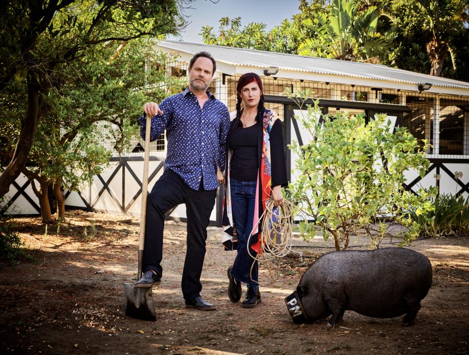 Wilson and Reinhorn strike an American Gothic pose by the barn. Amy, one of the couple’s two pigs, remains ever vigilant for snacks.