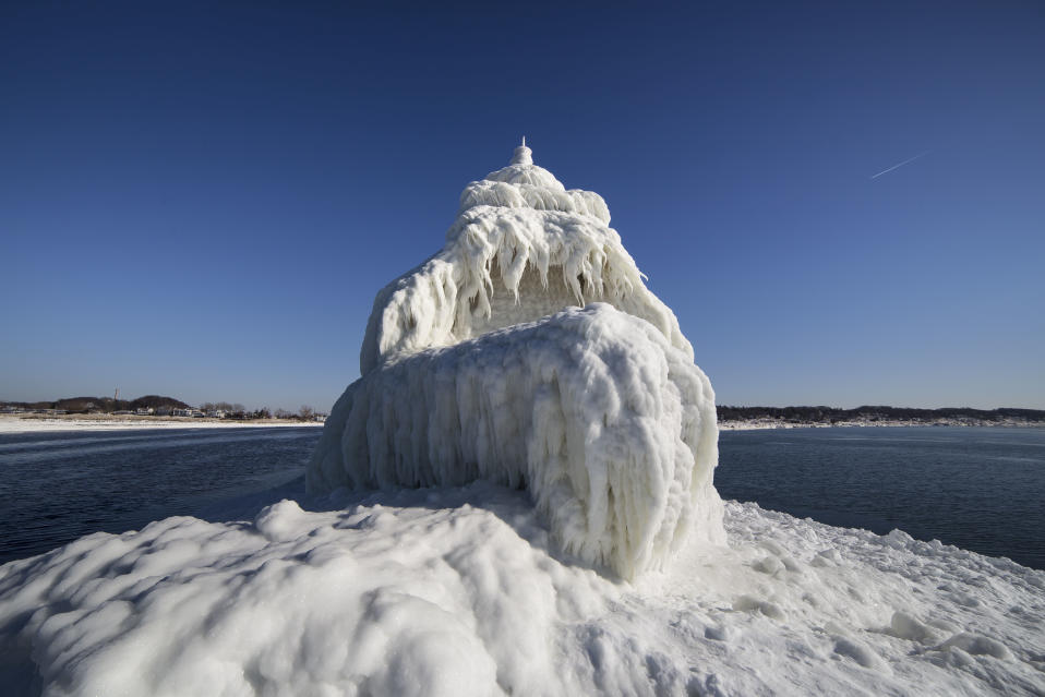 SOUTH HAVEN, MI - JANUARY 8: Ice frozen over the Grand Haven South Pier Entrance Light, on January 8, 2015, in South Haven, Michigan.ICE engulfs a red lighthouse as a fierce winter storm grips South Haven, Michigan. Sharp icicles and surreal formations can be seen hanging from the railings after strong waves crashed onto the piers. After each coating the water quickly freezes to ice and the pier is transformed into a slippery, white wonderland. Weather in the area dipped into the minus figures and froze over Lake Michigan in the beginning of January.PHOTOGRAPH BY Mike Kline / Barcroft MediaUK Office, London.T +44 845 370 2233W www.barcroftmedia.comUSA Office, New York City.T +1 212 796 2458W www.barcroftusa.comIndian Office, Delhi.T +91 11 4053 2429W www.barcroftindia.com