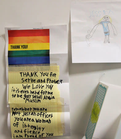 Washington Metropolitan Police Department Sergeant Jessica Hawkins, a transgender woman who leads the department's lesbian, gay, bisexual and transgender (LGBT) unit, displays mementos of support in her office in Washington, U.S. October 10, 2016. The display includes a drawing of Hawkins (top R) by a transgender child who hopes to be a police office also. REUTERS/Jonathan Ernst